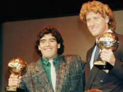Argentina’s Diego Maradona, left, and West German goalkeeper Harald Schumacher holding their awards during the Soccer Golden Shoe Award ceremony in Paris, France, in November 1986 (Michael Lipchitz/Ap)