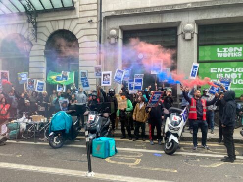 Deliveroo drivers protest outside the company’s AGM (Rebecca Speare-Cole/PA)