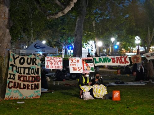 People stand guard outside an encampment set up by pro-Palestinian demonstrators on the campus at the University of Southern California (AP Photo/Ryan Sun)