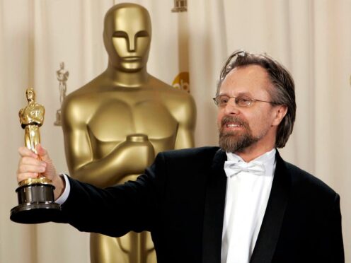 Jan A P Kaczmarek poses with the Oscar for best original score for his work on Finding Neverland during the 77th Academy Awards in February 2005 in Los Angeles (Reed Saxon/AP)