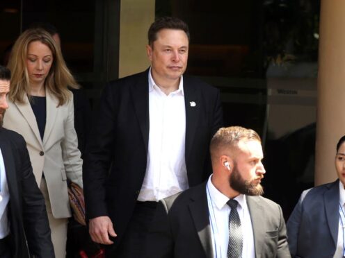 Elon Musk, centre, has been accused of being a part time chief executive at Tesla (AP Photo/Firdia Lisnawati, File)