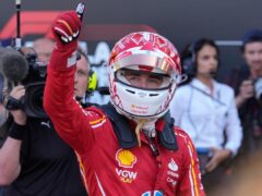 Ferrari driver Charles Leclerc celebrates taking pole position (Luca Bruno/AP).