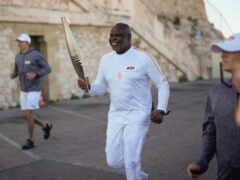 Basile Boli participates in the first stage of the Olympic torch relay in Marseille (Thibault Camus/AP)