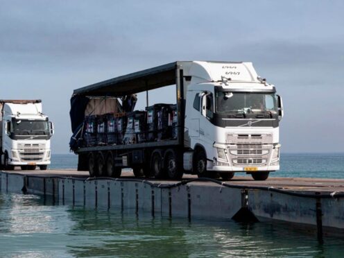 Trucks loaded with humanitarian aid cross the Trident Pier in Gaza (Staff Sgt Malcolm Cohens-Ashley/US Army Central via AP)