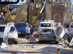 A man looks at a damaged car after a tornado in Valley View, Texas (AP Photo/Julio Cortez)