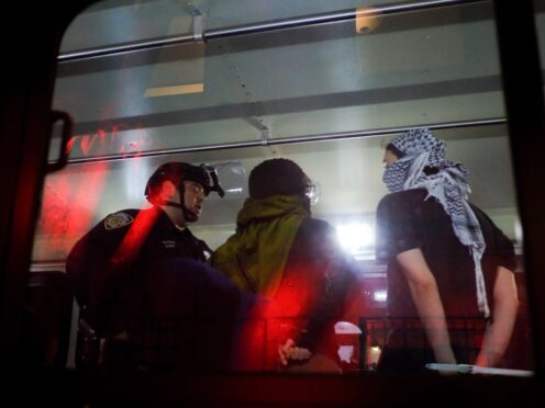 The NYPD load arrested protesters from Columbia University onto a bus (Julius Motal/AP)