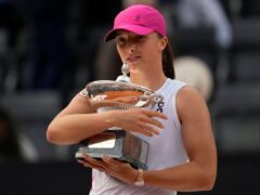 Iga Swiatek poses with the trophy after defeating Aryna Sabalenka in the final of the Italian Open (Alessandra Tarantino/AP/PA)
