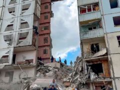 Russian emergency services work at the scene of a partially collapsed block of flats authorities said was hit during an attack by Ukrainian shelling, in Belgorod, Russia (Belgorod region governor/AP)