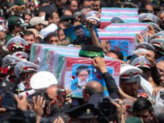 The flag-draped coffins of the late president Ebrahim Raisi and his companions who were killed in a helicopter crash on Sunday are carried during their funeral ceremony in the city of Mashhad, Iran (Iranian Presidency Office via AP)