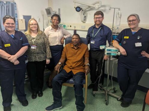 Elliot Pfebve, fourth left, with staff at Queen Elizabeth Hospital Birmingham (NHS England/PA)