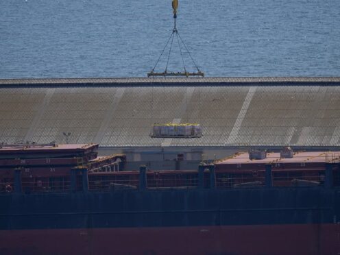 A crane loads food aid for Gaza onto a container ship docked in Cyprus (Petros Karadjias/AP)