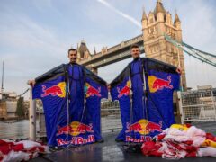Two professional skydivers successfully completed the world’s first wingsuit flight through London’s Tower Bridge.(Joerg Mitter/Red Bull/PA)