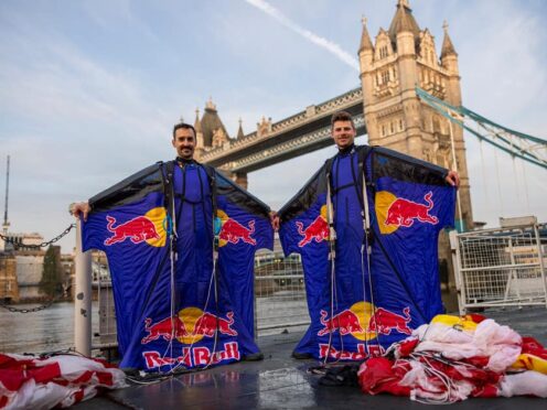 Two professional skydivers successfully completed the world’s first wingsuit flight through London’s Tower Bridge.(Joerg Mitter/Red Bull/PA)