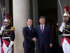 French President Emmanuel Macron shakes hands with China’s President Xi Jinping before their meeting at the Elysee Palace (AP)