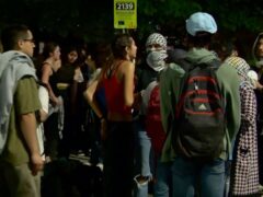 In this image taken from video, protesters against the Israel-Hamas war stand outside near the campus of George Washington University in Washington (AP)