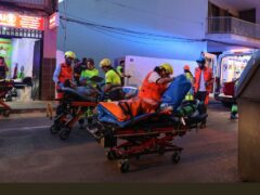 Medics take injured people away from a building that collapsed in Palma de Majorca (Isaac Buj/Europa Press via AP)