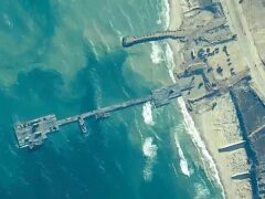 US Army soldiers assigned to the 7th Transportation Brigade (Expeditionary), US Navy sailors assigned to Amphibious Construction Battalion 1, and Israel Defence Forces placing the Trident Pier on the coast of Gaza Strip on May 16 (US Central Command/AP)