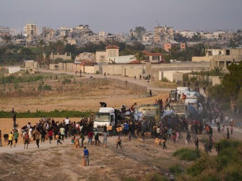 Palestinians are storming trucks loaded with humanitarian aid brought in through a new US-built pier, in the central Gaza Strip, Saturday, May 18, 2024. (Abdel Kareem Hana/AP)