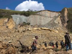 Villagers search through a landslide in Yambali village, in the Highlands of Papua New Guinea (Juho Valta/UNDP Papua New Guinea via AP)