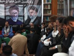 People attend a ceremony to pay tribute to Iranian president Ebrahim Raisi (AP Photo/Ikram Suri)