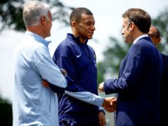 Kylian Mbappe shakes hands with French President Emmanuel Macron (Sarah Meyssonnier/Pool Photo via AP)