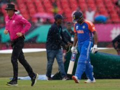 Rohit Sharma, right, leaves the field after rain stopped play (AP/Ramon Espinosa)