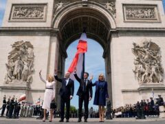 The US President and first lady took part in an event before the Arc de Triomphe (AP)