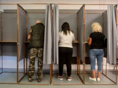 Voters fill in their ballot papers at a polling station during European Parliament and local elections in Salgotarjan, Hungary (Peter Komka/MTI/AP)