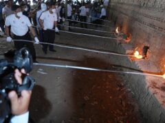 Cambodian officers burn drugs inside a brick kiln during a drug destruction ceremony (Heng Sinith/AP)