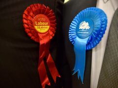 Conservative Party and Labour Party rosettes (Jannah McKay/PA)
