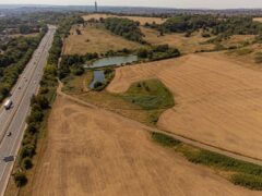 Dry grass fields next to the M32 motorway at Stoke Park, Bristol. The Met Office has issued an amber warning for extreme heat covering four days from Thursday to Sunday for parts of England and Wales. Picture date: Saturday August 13, 2022.