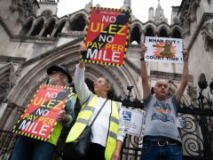 Anti-Ulez campaigners stage a demonstration outside the Royal Courts of Justice in central London (James Manning/PA)