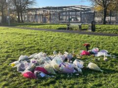 Floral tributes left at the scene in at Stowlawn playing fields in Wolverhampton where Shawn Seesahai was stabbed (Matthew Cooper/PA)