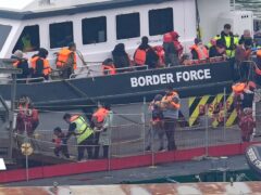 A group of people thought to be migrants, including young children, are brought into Dover from a Border Force vessel (Gareth Fuller/PA)