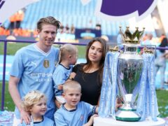 Kevin De Bruyne poses for a photo with wife Michele Lacroix and their three children (Martin Rickett/PA)