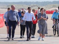 Prime Minister Rishi Sunak walks with husband and wife Ian and Maureen Levy, Conservative parliamentary candidates for Cramlington and Killingworth, and Blyth and Ashington, respectivley, at Blyth Beach in the North East of England while on the General Election campaign trail (PA)
