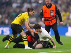Borussia Dortmund’s Marcel Sabitzer helps stadium stewards tackle a pitch invader (Nick Potts/PA)
