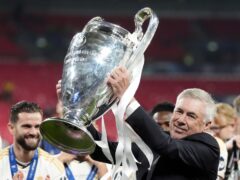 Real Madrid manager Carlo Ancelotti celebrates with the trophy after winning the Champions League final at Wembley (Nick Potts/PA)