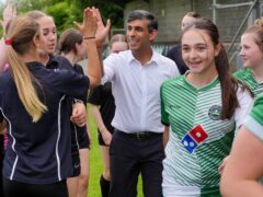 Prime Minister Rishi Sunak exchanges high fives with a member of Wantage Town Football Club during a visit to the club in Oxfordshire (Jonathan Brady/PA)