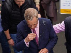Leader of Reform UK Nigel Farage after a drink was thrown over him as he leaves the Moon and Starfish pub in Clacton (James Manning/PA)