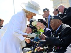 The Queen receives a white rose from veteran Gilbert Clarke (Chris Jackson/PA)