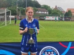 Lily Lucas of Thornaby FC’s girls’ under 15s lifts a trophy. The club has been hit by a backlash after officials said it was axing its female section (Family handout/PA)