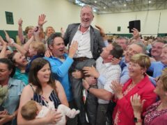 Sean Kelly celebrates with friends, family and supporters after becoming the first MEP to be elected in Ireland’s European elections at Nemo Rangers GAA club in Cork, Ireland, during the count for the European elections (Jonathan Brady/PA)
