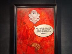 Animal rights protesters have pasted the face of the character Wallace, from Wallace and Gromit, over a portrait of the King at a London gallery (Animal Rising/PA)