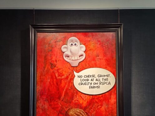 Animal rights protesters have pasted the face of the character Wallace, from Wallace and Gromit, over a portrait of the King at a London gallery (Animal Rising/PA)