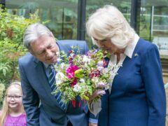 The Queen Camilla is welcomed by Alan Titchmarsh during a visit to the Gardening Bohemia exhibition at the Garden Museum, in Lambeth, south London (Arthur Edwards/The Sun/PA)