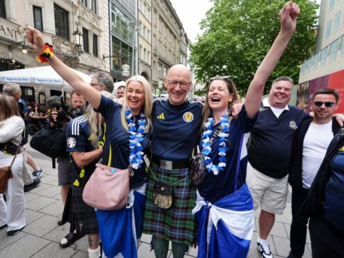 First Minister of Scotland John Swinney posing for photos with Scotland fans at Marienplatz square, Munich (Andrew Milligan/PA)