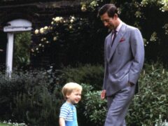 Photo from 1984 of William playing football in the garden of Kensington Palace with his father Charles (PA)