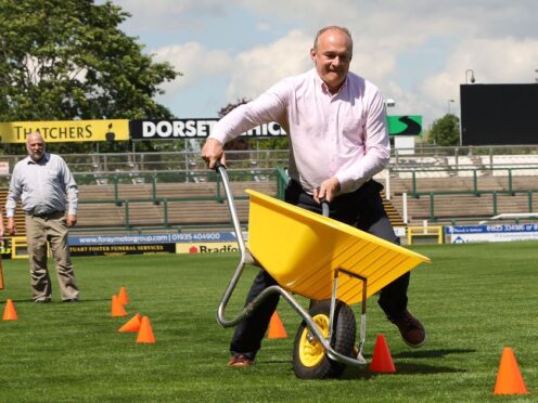 Lib Dem leader Sir Ed Davey took part in a wheelbarrow race on Monday while on the campaign trail in Yeovil in Somerset (Will Durrant/PA)