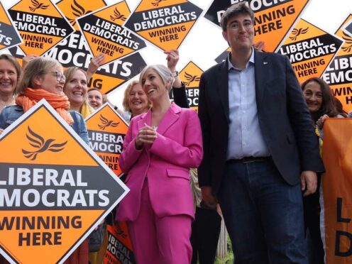 Liberal Democrat deputy leader Daisy Cooper (in pink) with Godalming and Ash candidate Paul Follows on the campaign trail in Surrey (Will Durrant/PA)